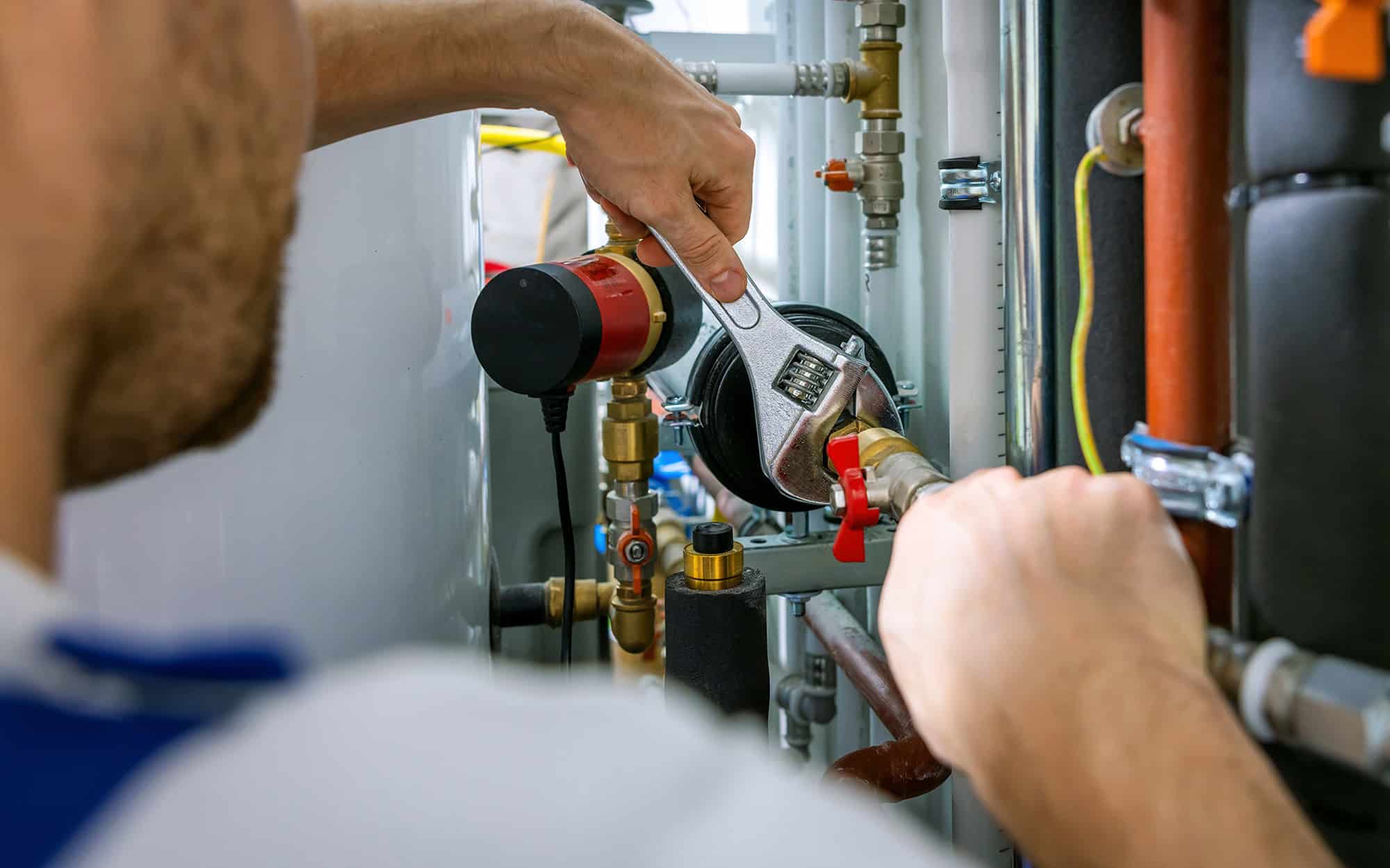 plumber working with wrench. screws the pipe fittings Plumber Working With Wrench. Screws The Pipe Fittings